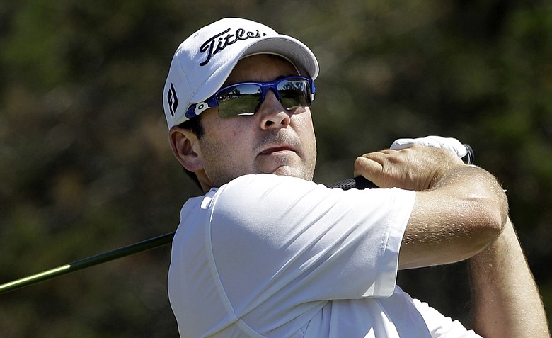Ben Curtis watches his tee shot on the first hole during the final round of the Texas Open.