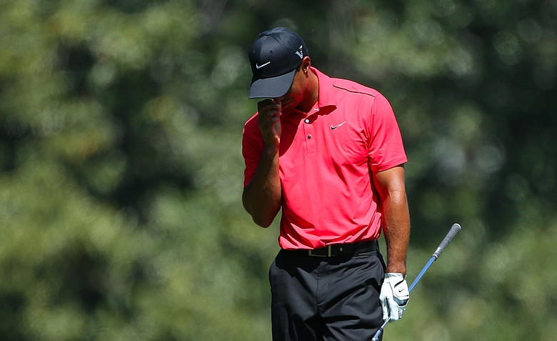 Tiger Woods of the United States reacts after an approach shot on the fifth hole during the final round of the 2012 Masters Tournament at Augusta National.
