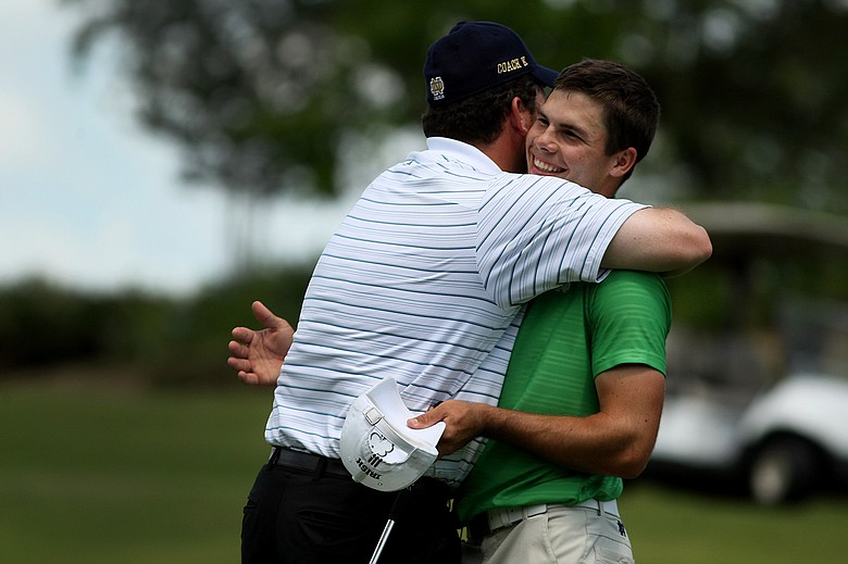 Notre Dame head coach Jim Kubinski hugs Max Scodro after they won the Big East Men's Championship at Reunion Resort by 16 shots. Scodro won individual honors by 1 stroke after making a double bogey at No. 18.