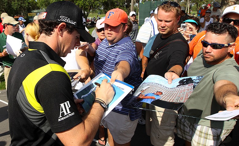 Rory McIlroy signs his autograph for fans during a practice round prior to the start of THE PLAYERS Championship.