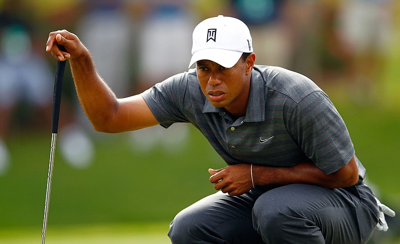 Tiger Woods lines up a putt on the 13th hole of TPC Sawgrass' Stadium Course during the first round of The Players Championship in Ponte Vedra Beach, Fla. Woods shot 2-over 74.