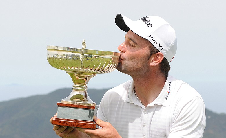 Portugal's Ricardo Santos poses for photos with his trophy after winning the Madeira Islands Open European Tour golf tournament.
