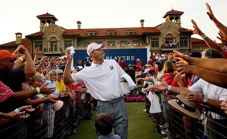 Matt Kuchar tosses signed flags after he won The Players Championship at TPC Sawgrass.