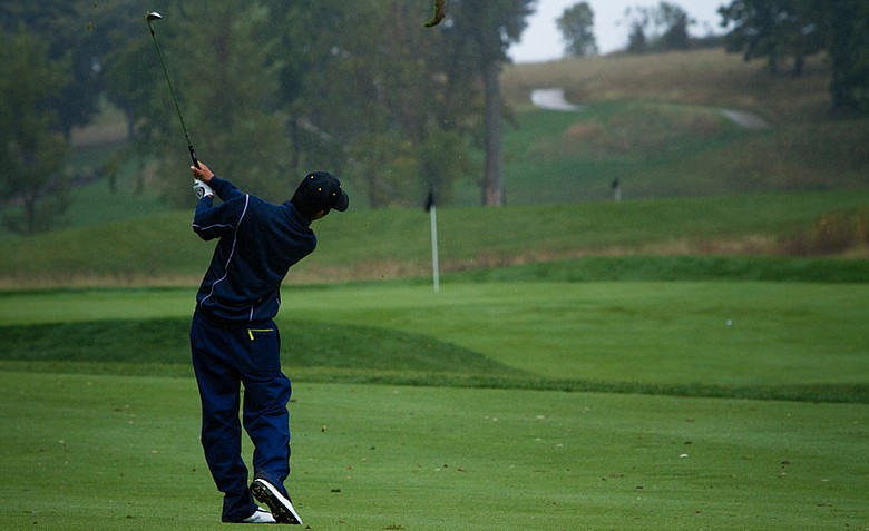 Cal freshman Michael Kim takes a large divot as he hits his approach on No. 18 at the Golfweek Conference Challenge.