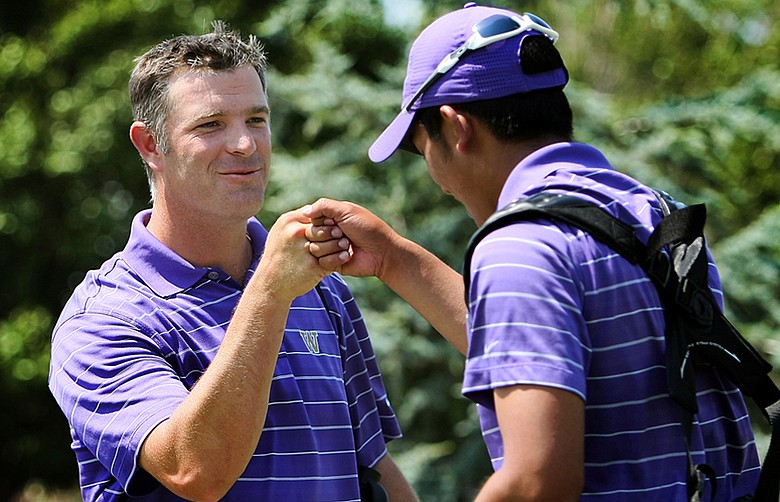 Washington's head coach Matt Thurmond fist bumps his last player of the day, Cheng-Tsung Pan after they won during the final round of the Southwest Regional Championship at Jimmie Austin Golf Club.