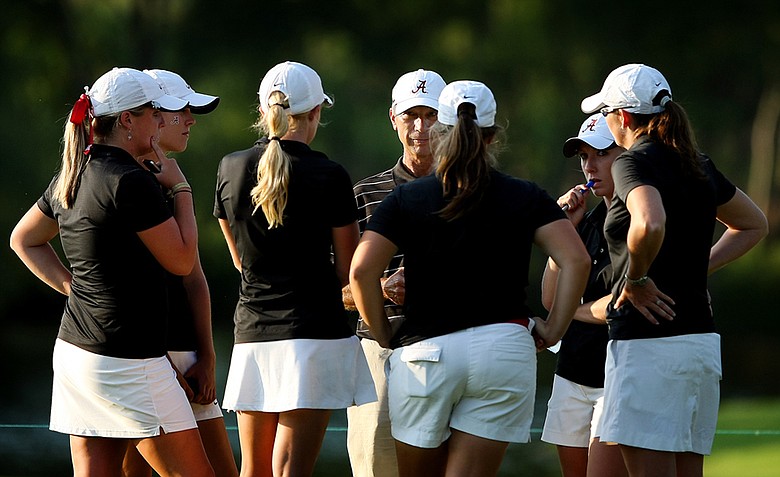 Alabama head coach, Mic Potter, center, talks with his players after their round on Thursday at the 2012 NCAA Division I Women's Golf Championships. Alabama began the day with an 11 shot lead that dwindled two 2.
