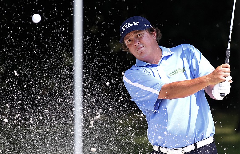 Jason Dufner hits out of a bunker onto the eighth green during the second round of the PGA Colonial golf tournament Friday, May 25, 2012, in Fort Worth, Texas.