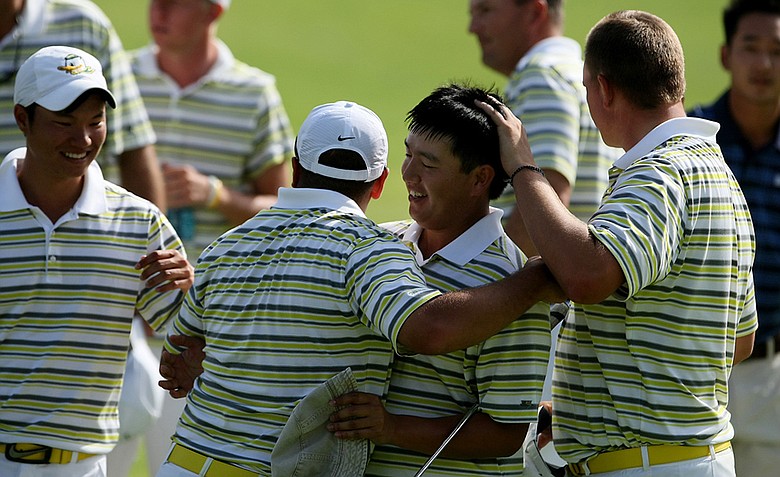 Oregon's Eugene Wong is surrounded by teammates after he defeated UCLA's Anton Arboleda during the first day of Match Play at the 2012 NCAA Championship. Oregon will face Texas in the semifinals.