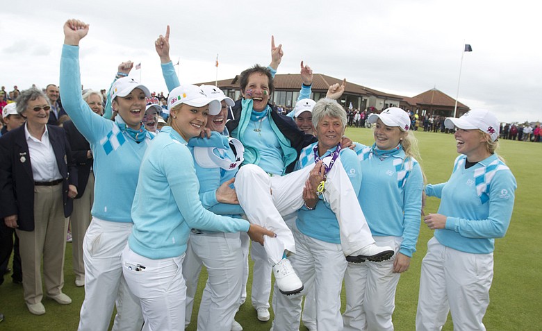 GB&I team lifted their captain Tegwin Matthews on the 18th green after its 10.5-9.5 victory in the Curtis Cup at The Nairn Golf Club in Nairn, Nairnshire, Scotland.