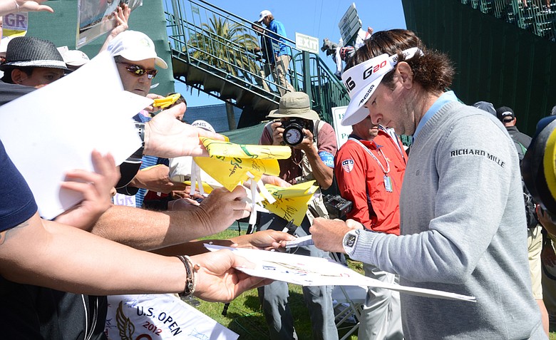 Bubba Watson signs autographs after completing his 10th and final hole at the par-4 18th during a practice round at Olympic Club in San Francisco.