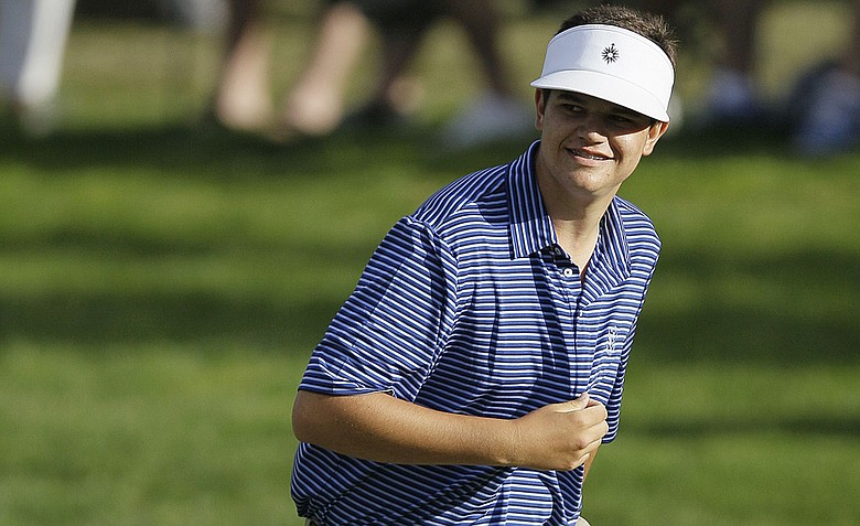 Amateur Beau Hossler smiles as he walks up the 18th hole during the third round of the U.S. Open Championship golf tournament Saturday, June 16, 2012, at The Olympic Club in San Francisco.