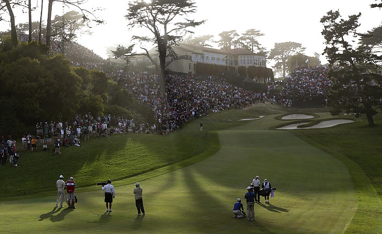 Tiger Woods and Jim Furyk make their way up the 18th hole on Saturday at Olympic Club.
