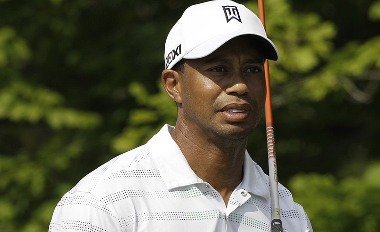 Tiger Woods watches his tee shot on the 17th hole as it went out of bounds during the first round of the Greenbrier Classic.