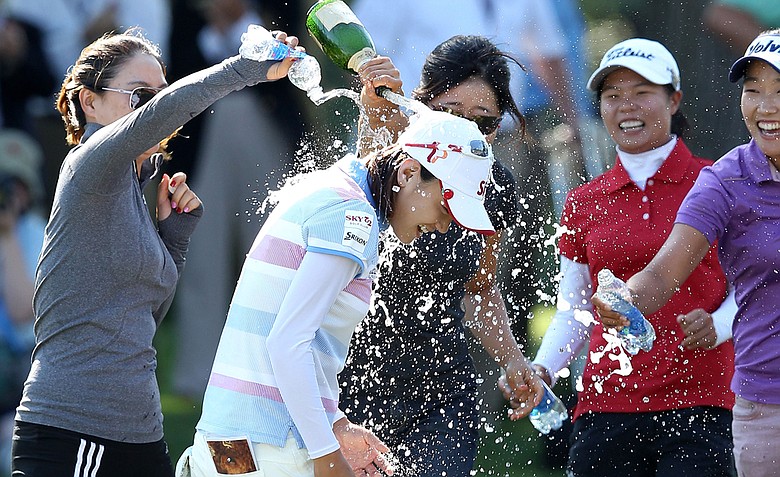 Na Yeon Choi is sprayed with champagne by players and friends after her four-stroke victory at the 2012 U.S. Women's Open.