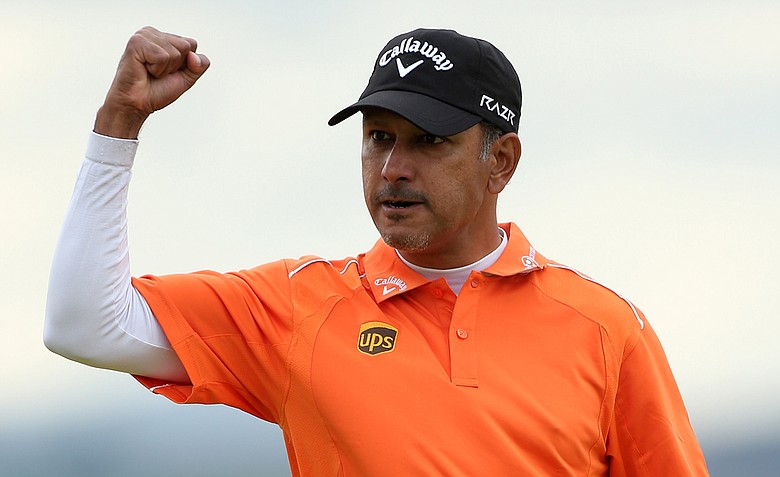 Jeev Milkha Singh celebrates holing a putt during a playoff against Francesco Molinari to win on the 18th green during the final round of the Scottish Open at Castle Stuart Golf Links.