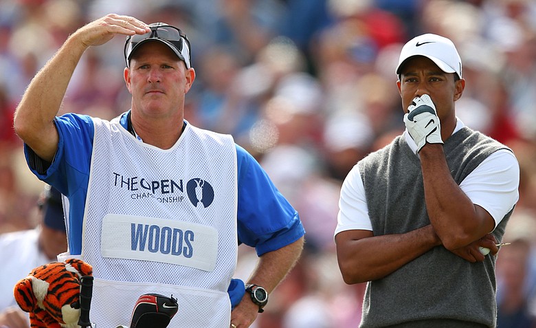 Tiger Woods looks on alongside caddie Joe LaCava before hitting his tee shot on the fifth hole during the third round of the 141st Open Championship at Royal Lytham & St. Annes Golf Club.