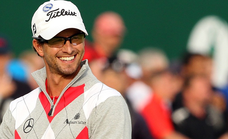 Adam Scott smiles as he walks onto the 18th green during the third round of the 2012 Open Championship at Royal Lytham and St. Annes.
