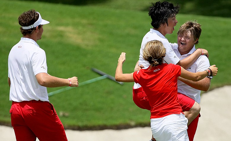 The East's Cody Proveaux is mobbed by his teammates after he won his single match against Brad Dalke allowing the East to retain the 2012 Wyndham Cup.
