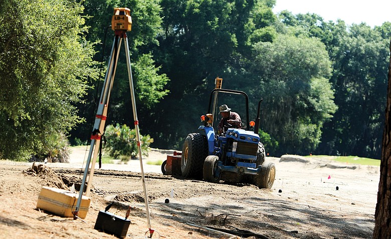 A worker with MacCurrach Golf Construction works on leveling the tee box at Hole No. 9 during renovations at Old Tabby Links on Spring Island in South Carolina.