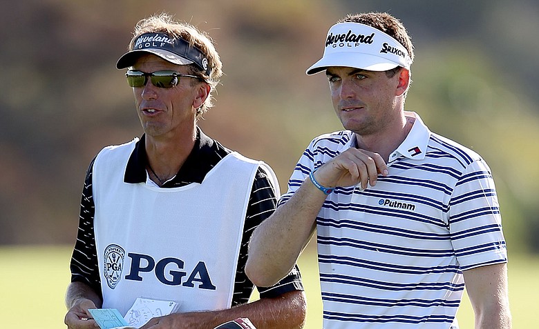 Caddie Steve "Pepsi" Hale, left, and Keegan Bradley line up a shot on the 11th fairway during Day 1 of the 94th PGA Championship.