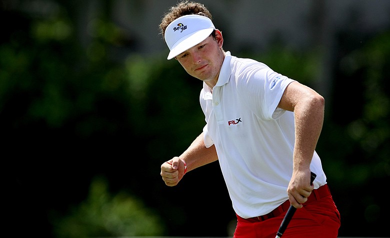 Matthew NeSmith pumps his fist as he wins his match at Hole No. 16 against West's Thomas Lim during Thursday's single matches.
