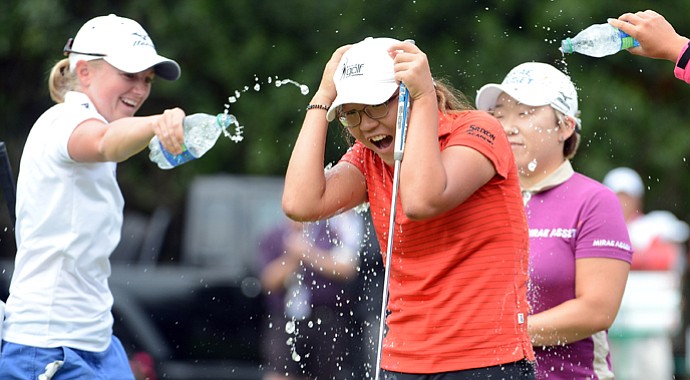 Lydia Ko is doused with water by Stacy Lewis, Jiyai Shin in celebration of her three-shot victory at the Canadian Women's Open.