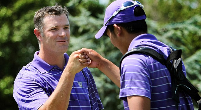Cheng-Tsung Pan (right) gets a fist-bump from Washington head coach Matt Thurmond. Pan led the Huskies to a home victory on Sept. 18.