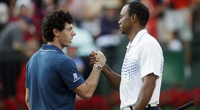Rory McIlroy and Tiger Woods shake hands after the first round of the Tour Championship.