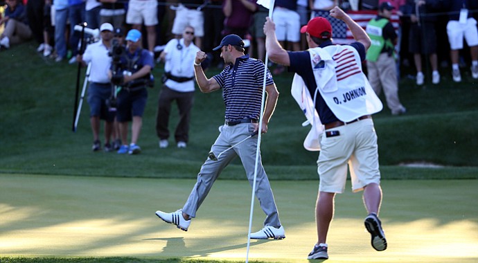 Dustin Johnson of the USA celebrates his birdie putt on the 17th green during day two of the afternoon four-ball matches at the 39th Ryder Cup at Medinah Country Club.