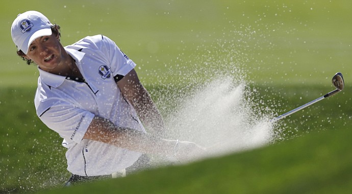 Europe's Rory McIlroy hits out of a bunker on the 14th hole during a singles match at the Ryder Cup PGA golf tournament Sunday, Sept. 30, 2012, at the Medinah Country Club in Medinah, Ill.