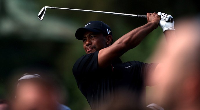 Tiger Woods tees off on the 15th hole against Charl Schwartzel during Day 1 of the Turkish Airlines World Golf Final.