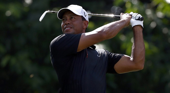 Tiger Woods watches his tee shot on the 2nd hole during the second round of the CIMB Classic.