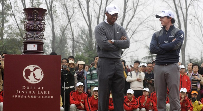 Tiger Woods and Rory McIlroy talk at the award ceremony during the Duel at Jinsha Lake Golf Club on Oct. 29, 2012.