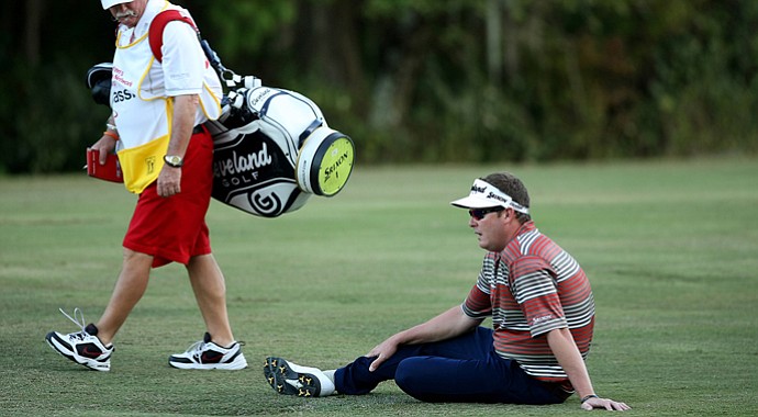 Charlie Beljan sits in the fairway at No. 18 as he tries to get through his round on the Palm Course during the Children's Miracle Network Hospitals Classic. He is the tournament leader.