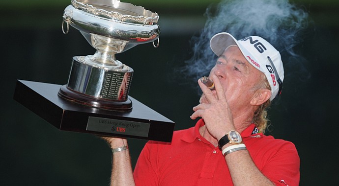 Miguel Angel Jimenez with the winners trophy and his cigar after the final round of the UBS Hong Kong Open.