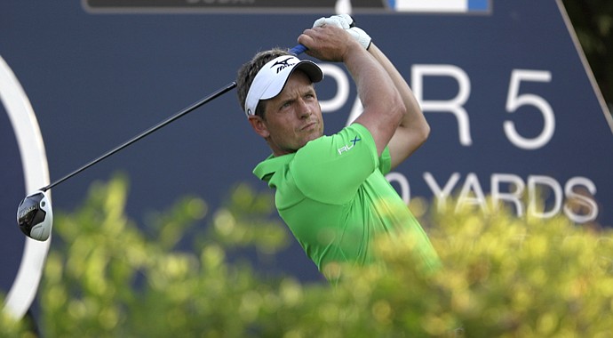 Luke Donald eyes his tee shot on the 18th hole during the first round of DP World Golf Championship in Dubai.