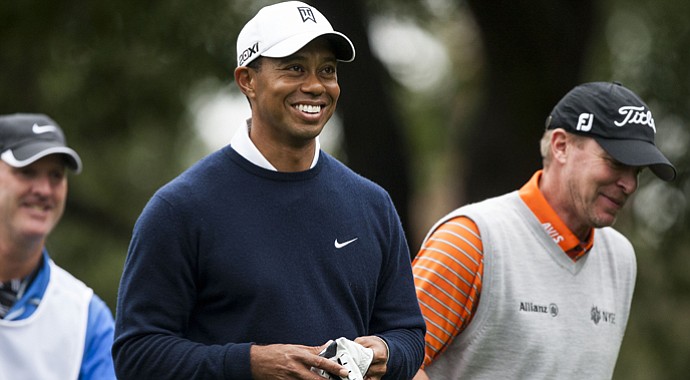 Tiger Woods shares a laugh with Steve Stricker during the first round of the World Challenge in Thousand Oaks, Calif.