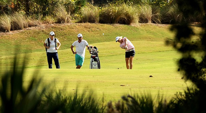 Melissa Reid of England with her caddie Johnny Scott and Annie Mallory of CoreGolf Academy during a practice round for LPGA Q-School.
