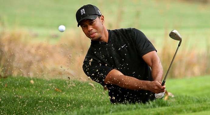 Tiger Woods hits out of a bunker on the fourth hole during the third round of the Tiger Woods World Challenge.