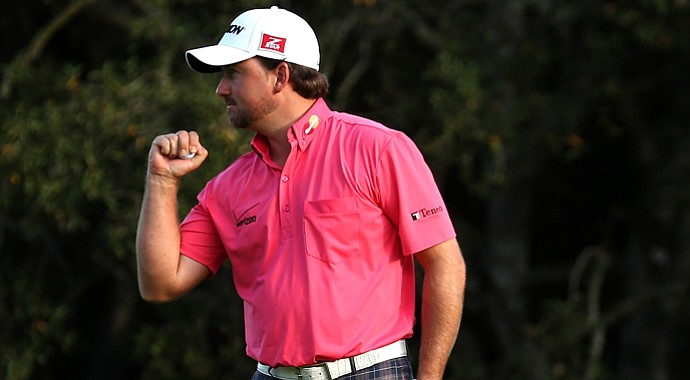 Graeme McDowell pumps his fist after making a birdie putt on the 18th hole to cement a three-stroke victory during the final round of the Tiger Woods World Challenge.