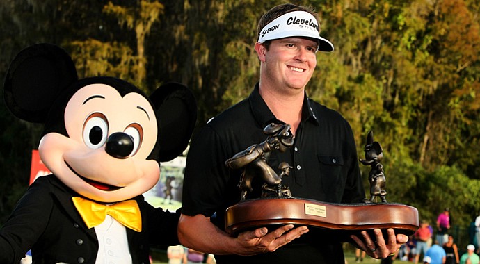Charlie Beljan and Mickey Mouse on the 18th green of Magnolia Course after he won the Children's Miracle Network Hospitals Classic.