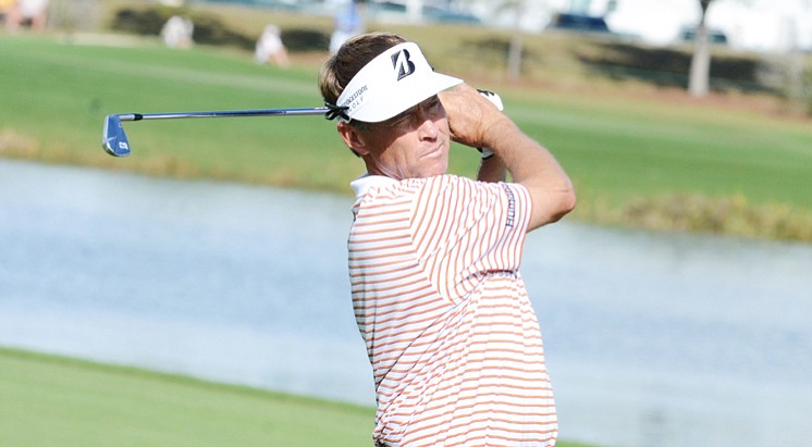 Davis Love III hits from the middle of the 18th fairway during the first round of the Father/Son Challenge at the Ritz-Carlton Golf Club in Orlando.