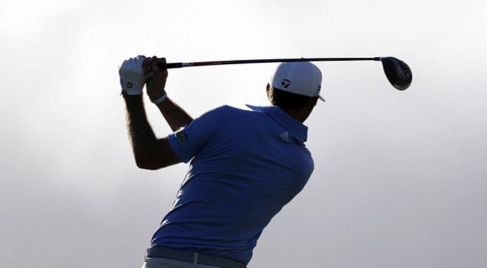 Dustin Johnson tees off on the fourth hole during the third and final round at the Hyundai Tournament of Champions.