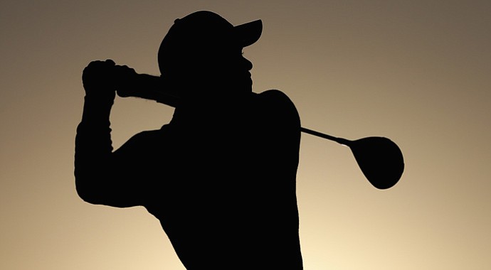 Tiger Woods hits his tee shot on the first hole during the first round of the Abu Dhabi HSBC Golf Championship.