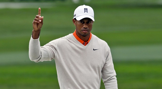 Tiger Woods gestures after his shot out of a bunker on the par-5 sixth hole on the South Course at Torrey Pines goes into the cup for an eagle during the first round of the Farmers Insurance Open golf tournament Thursday Jan. 24, 2013, in San Diego.