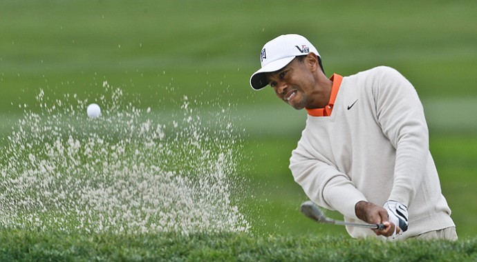 Tiger Woods blast from the bunker on the par-5 sixth hole of the South Course at Torrey Pines during the first round of the Farmers Insurance Open golf tournament, Thursday, Jan. 24, 2013, in San Diego. Woods sank the shot for an eagle.