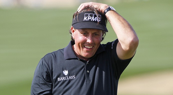 Phil Mickelson reacts after missing his birdie putt on the ninth hole that would have given him a round of 59 during the first round of the Waste Management Phoenix Open.