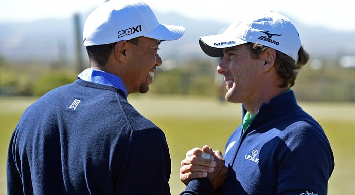Tiger Woods greets his first-round opponent, Charles Howell III, during a practice round on Tuesday.