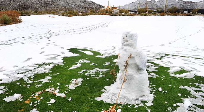 A snowman hitting a golf ball is seen on the course as snow and rain caused play to be suspended due to weather during the first round of the WGC-Accenture Match Play Championship.