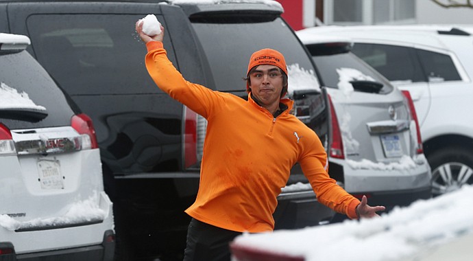 Rickie Fowler throws snowballs at fellow players in the parking lot after a snow storm suspended the Match Play Championship.